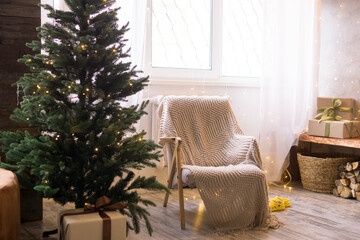 Home New Year's interior. Christmas tree with gifts, decorated with garlands. Cozy atmosphere of a home holiday, loft design of the room, Scandinavian style