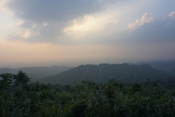 sunset in the mountains. Beautiful Maraingtong Hill, clouds over the mountains, view from the top of mountain, view of a forest, natural beauty Bandarban. Bangladesh.