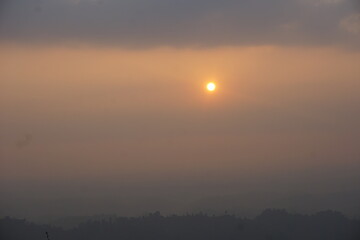 sunrise over the mountains. Beautiful Maraingtong Hill, clouds over the mountains, view from the top of mountain, view of a forest, natural beauty Bandarban. Bangladesh.