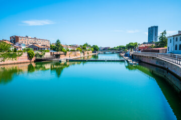 A view from the Roman Tiberius Bridge along the estuary out to sea at Rimini, Italy in summertime