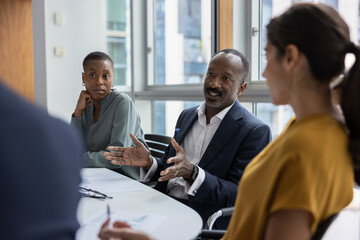 Mature black businessman leading a corporate business office meeting