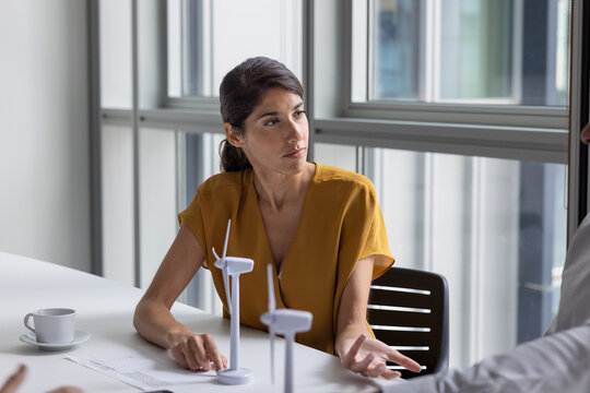 Businesswoman in a board meeting to discuss wind power and green energy