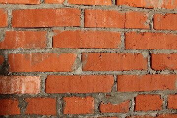 Obraz premium brick macro photo. Brick wall, close-up of red bricks with concrete between the seams. Construction background