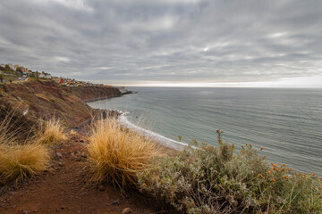 Seascape. Calm sea. Ocean views from the cliff. Sunset at sea. Views of the village of Bajamar and natural pools. Tenerife, Bajamar, Canary Islands.