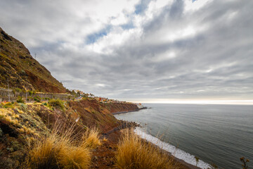 Seascape. Calm sea. Ocean views from the cliff. Sunset at sea. Views of the village of Bajamar and natural pools. Tenerife, Bajamar, Canary Islands.
