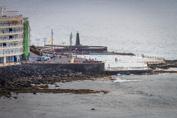 Seascape. Calm sea. Sunset at sea. Views of the village of Bajamar and natural pools. Tenerife, Bajamar, Canary Islands.