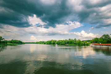 A cloudy sky with a river in the background