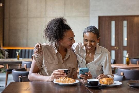 Mother and daughter in a cafe together 