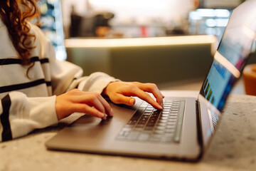 Close-up of hands working on a laptop keyboard. Cyber security. Business, Freelance, Shopping, education. Online.