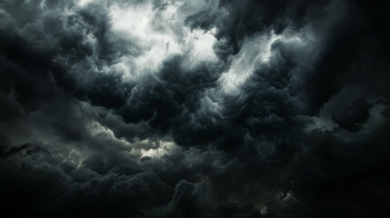 Fototapeta premium Dark, heavy clouds gather in the sky, threatening a fierce storm. The ominous weather signals the arrival of rain.