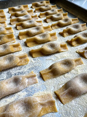 A tray of fresh, stuffed pasta made by hand