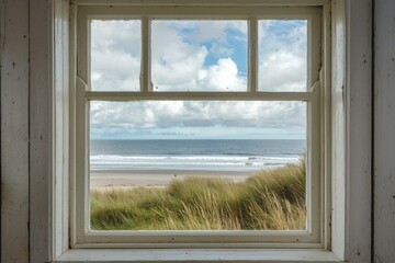 A window in a small coastal cottage, overlooking a serene beach with gentle waves.