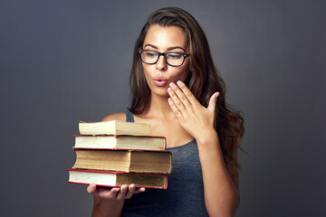 Student, surprise and books with woman with university, college and library study textbook in studio. Wow, knowledge and school learning wonder of banned story with education and dark background