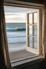 A window in a small coastal cottage, overlooking a serene beach with gentle waves.