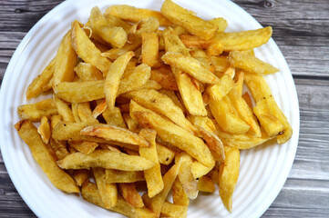 French fries, chips, finger chips, french-fried potatoes, or simply fries, batonnet or allumette-cut deep-fried potatoes of disputed origin from Belgium or France, cutting potatoes into even strips