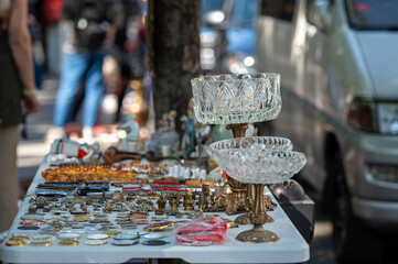 Open-Air Market Stall Displaying Vintage Jewelry And Antique Items During Sunny Day