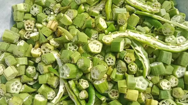 Top view of uncooked Chopped okra slices.Cutted lady finger pieces pattern background. Chopped Abelmoschus esculentus pile 