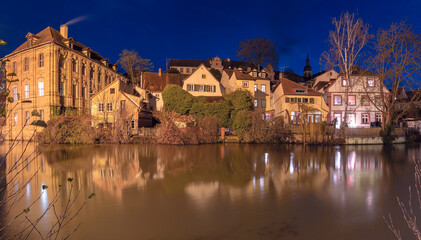 Illuminated night view of Bamberg Old Town with reflections on the Regnitz River in Bamberg, Germany