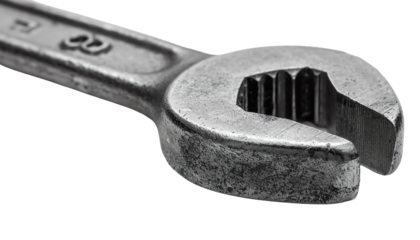 Close-up of a metal wrench with a shiny finish and detailed grooves, isolated on transparent background.