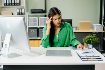 Business woman is stressed, bored, and overthinking from working on a tablet