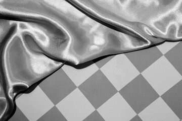 Black and white abstract background with retro pattern combined with satin fabric