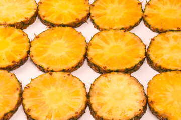 Pineapple juicy yellow slices on a white background.