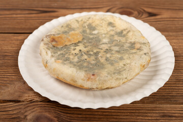 angle view moldy cake on a dish