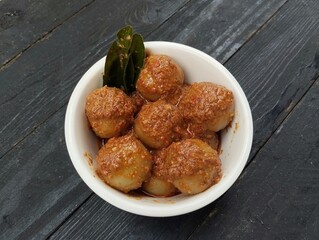 Indonesian food cilok bumbu kacang is a food made from flour and sago with peanut sauce on the wooden table