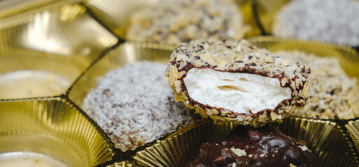 A bitten marshmallow with a dissatisfied anthropomorphic face. Pareidolia. Angry grimace. The...