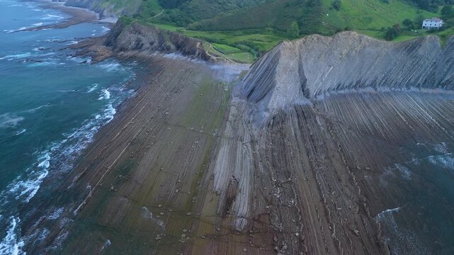 Low tide at the Sakoneta Flysch and Punta Mendata on the Cantabrian Coast in Deva. Aerial view from a drone. Cantabrian Sea. Gipuzkoa Province. Basque Country. Spain. Europe