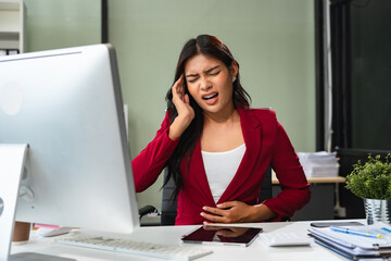 Tired asian businesswoman with headache at office, feeling sick and Chest pain, Woman feeling sick.