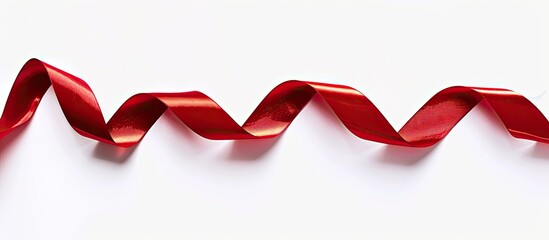 A red satin ribbon on a white background with ample copy space image available
