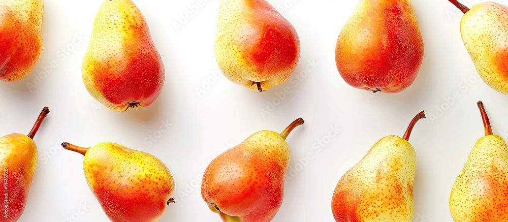 Poster Overhead view of vibrant ripe pear fruits in red and yellow shades set against a white backdrop providing space for text or other elements in the image. Creative banner. Copyspace image