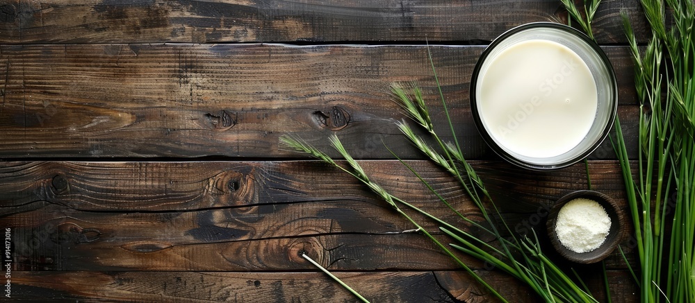 Poster flat lay wooden table with a glass of milk and grass jelly with room for text in the image. creative
