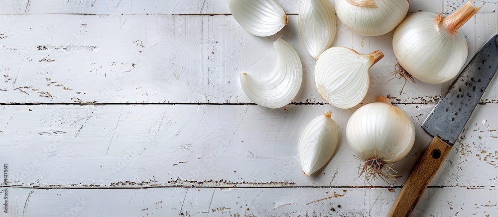 Poster onion being sliced on a white wooden surface with space for text or images. creative banner. copyspa
