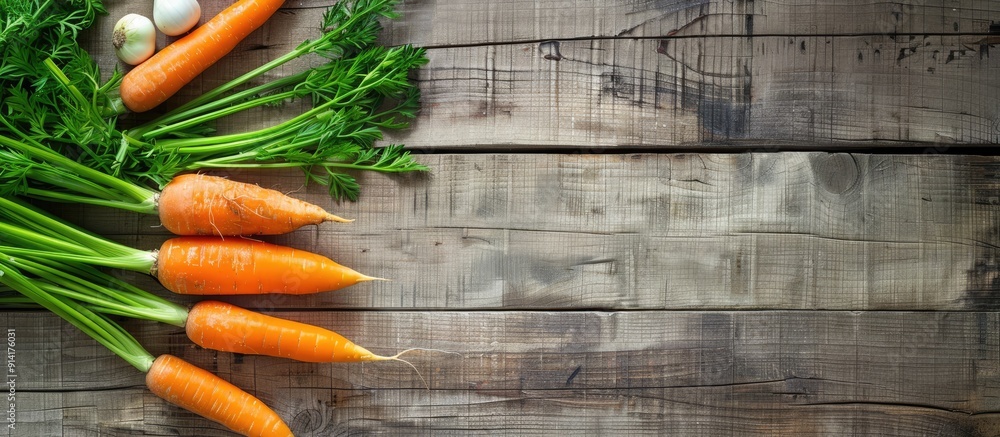 Aufkleber Fresh carrot and spring onion on a wooden table surface with copy space image