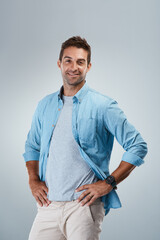 Portrait, casual and happy man with fashion, smile or trendy outfit for confidence on grey...
