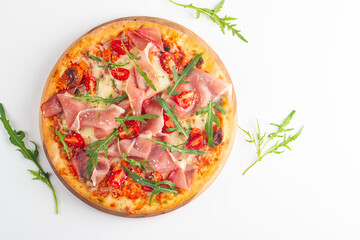 Pizza with prosciutto, ham, arugula, spinach, tomatoes, pesto, cheese and parmesan. Italian cuisine
