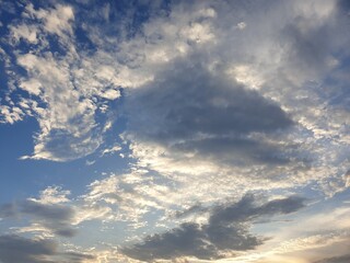 Deep natural blue sky with white and black clouds.