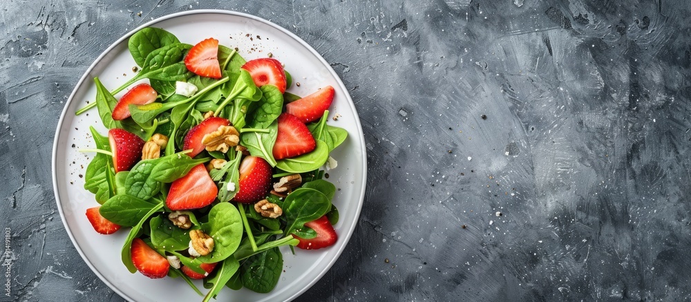 Poster fresh strawberries spinach cream cheese and walnuts create a light healthy summer salad displayed on