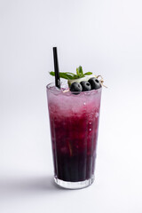 Cocktail with blueberries and mint on a white background.