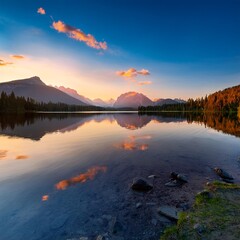A tranquil lake at sunset with mountains in the background and a perfect reflection on the water
