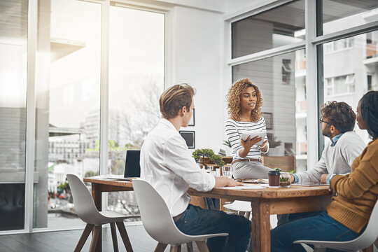 Business people, teamwork and planning in meeting, tablet and conversation with design company. Group, employees and startup with feedback for project, cooperation and professional with brainstorming