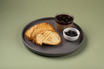 Portion of chicken liver pate with currant jam and toasts