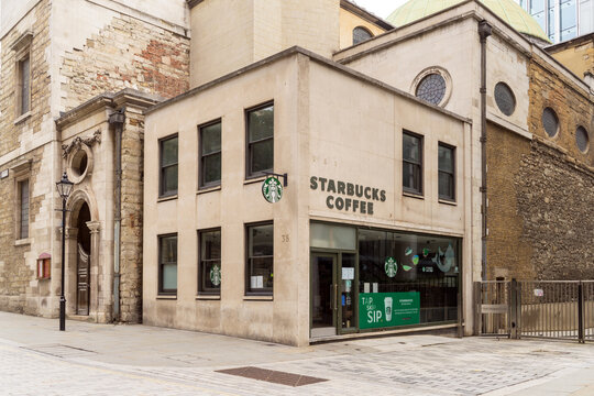 A gentrified Starbucks Coffee shop on the corner of St Stephen Walbrook Anglican Church. London - 22nd August 2021