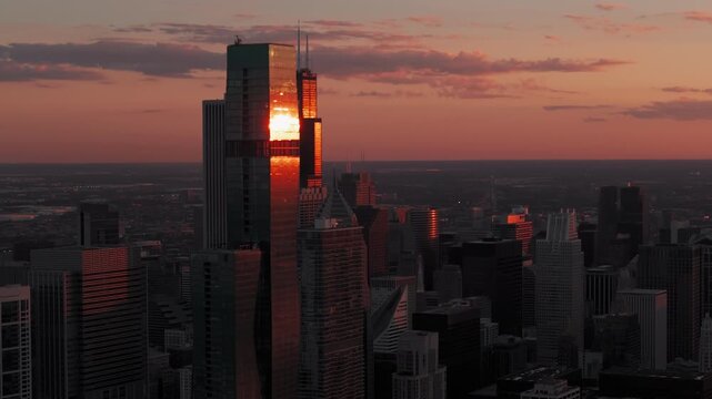 Chicago downtown skyline on gold sunset evening time. Drone aerial footage