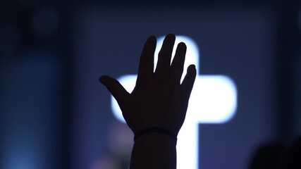 A man raising his hand in worship at a Christian church service
