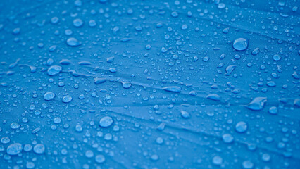 Water Drops on Blue Umbrella, Close-up of Rain on Umbrella Fabric stock Images.