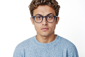 Fototapeta premium Young man in glasses looking skeptical