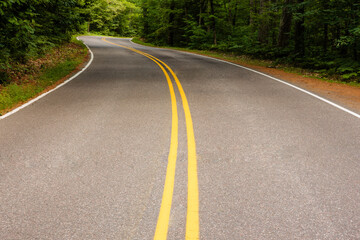Dark shadows cast across scenic Highway K in Vilas County, Wisconsin, in late August